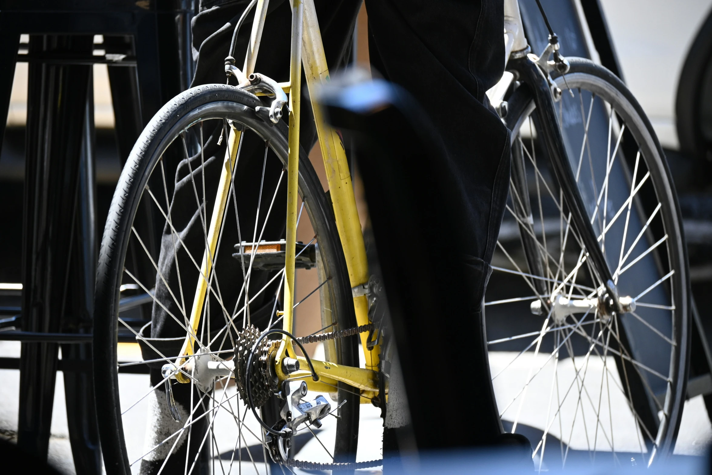 an old man is standing next to a bicycle