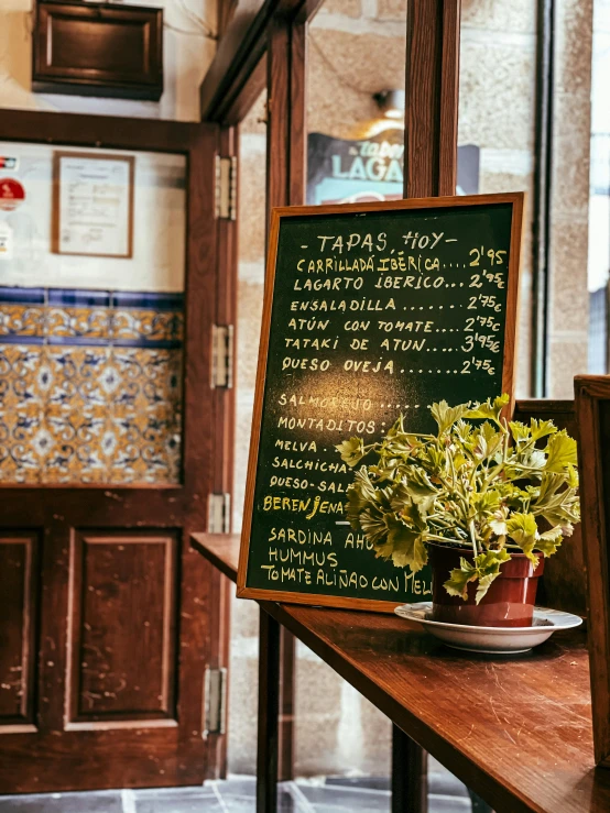 a restaurant sign has been written out on the board