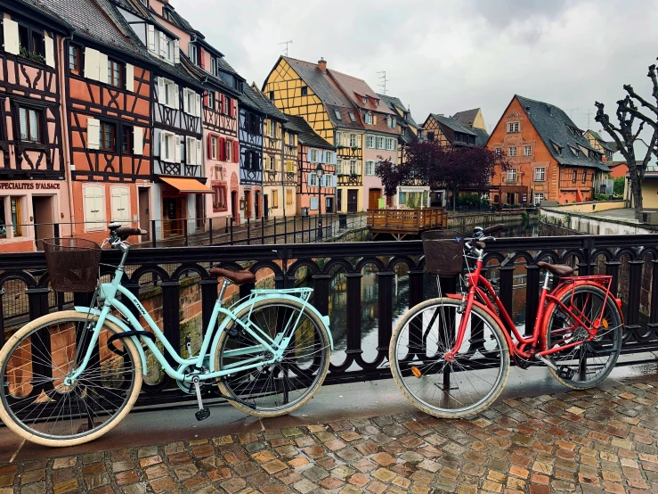 two bikes parked on a street in front of some houses