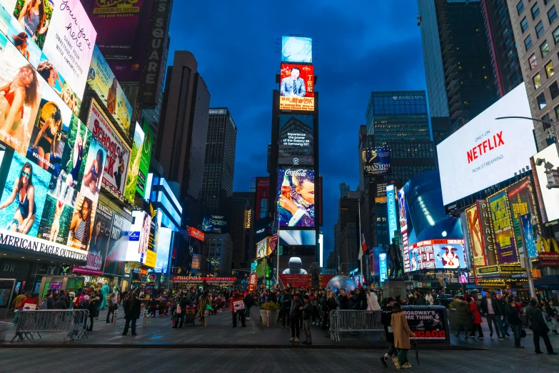 a crowded street filled with lots of neon billboards