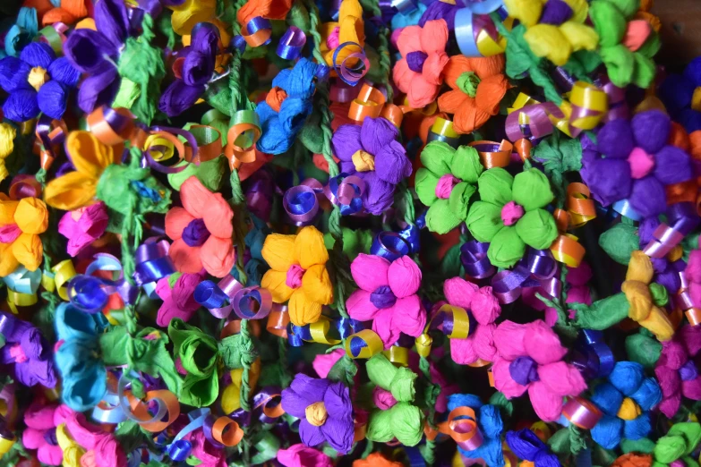 a lot of different colors flowers made from felt