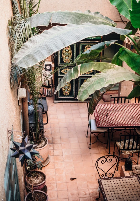 an aerial view of an empty patio area with a few tables and benches