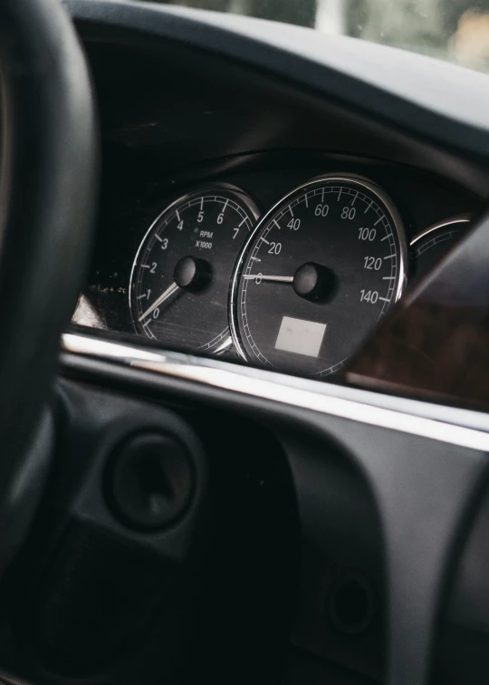 the dashboard of a car with meters