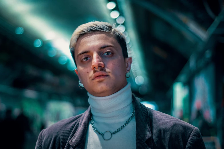 the young man is standing in the subway station