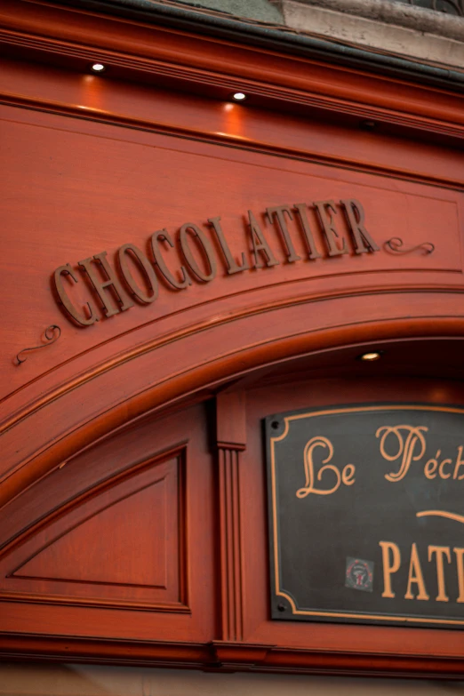 the door of a restaurant with a plaque and sign above it