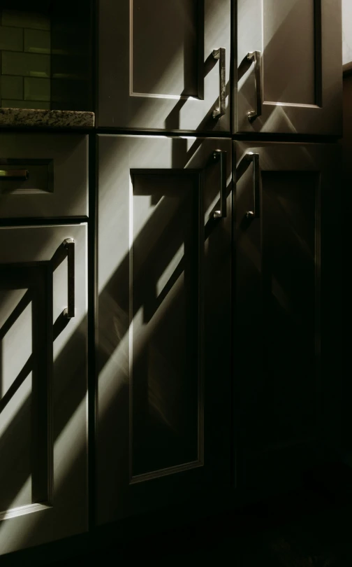a dark po of a kitchen with a large window
