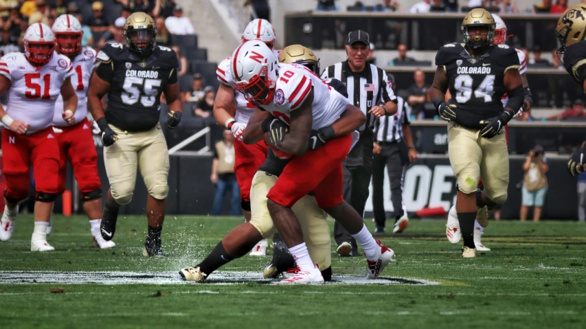 the football players are running and being chased by the defenders