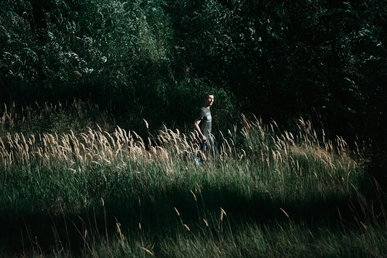 there is a man walking alone in the field