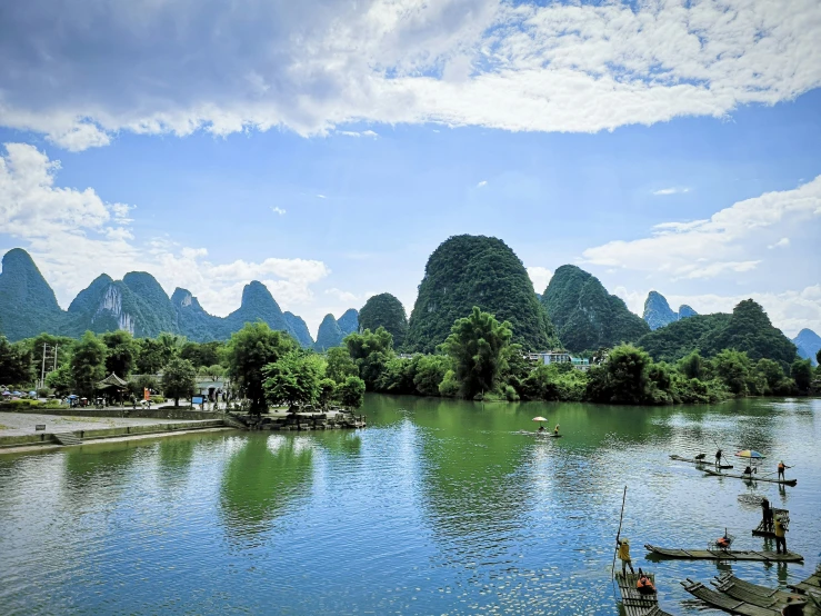 fishing boats are moored at the dock near mountains