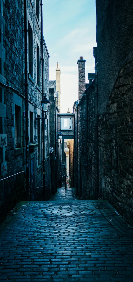 a narrow brick street that runs through old buildings