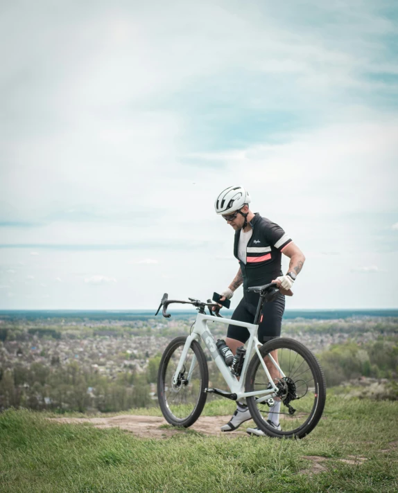 a man riding his bike on top of a hill