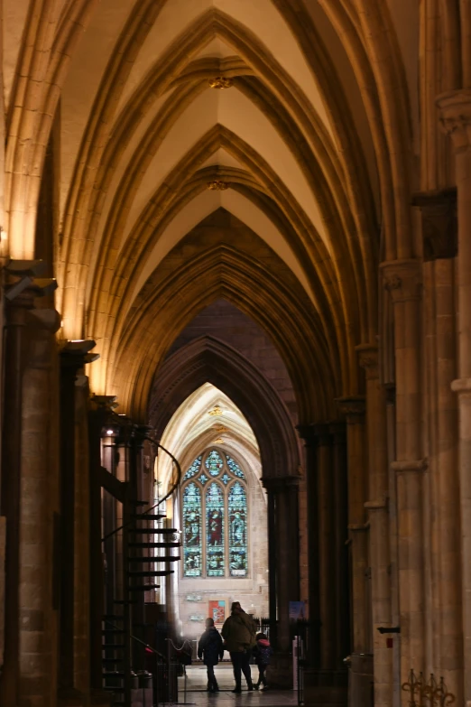 a person walking down a hallway into a cathedral