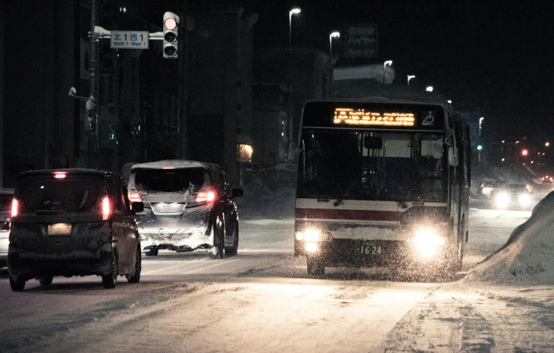 a bus and cars on a snowy road