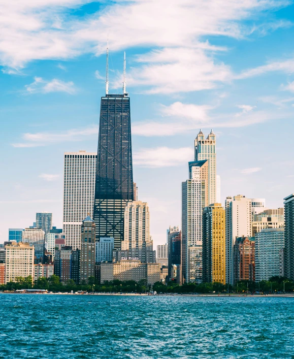 the tall buildings are on the skyline across the water