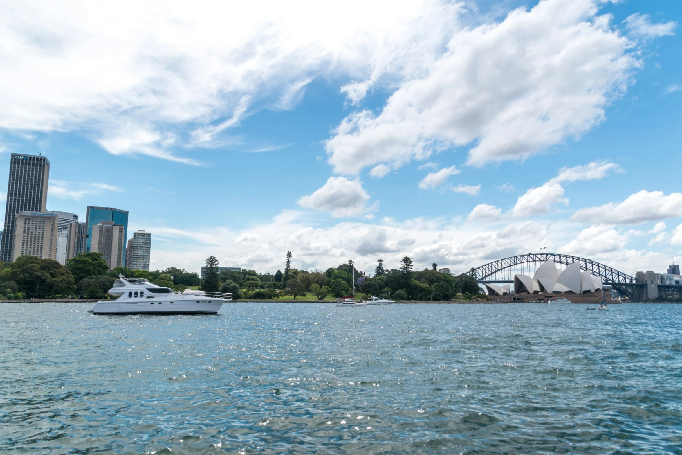 boats are floating in a lake near the opera house