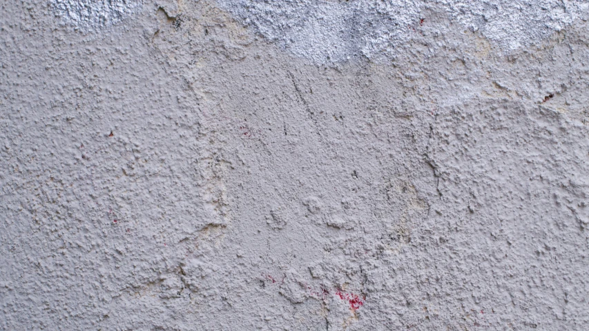 an area with cement with paint chipped around the wall