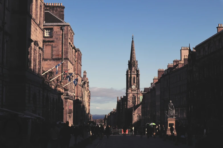 a street with many buildings and people walking on the sidewalks