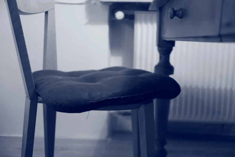 a blue and white po of a chair with a black cushion