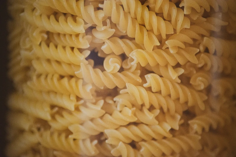 a pasta meal is mixed with grated cheese