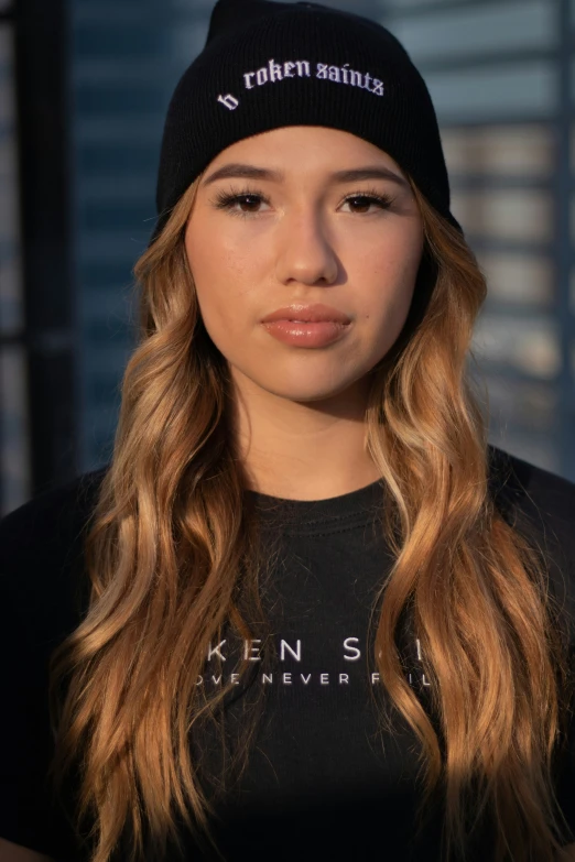a woman in a black t - shirt and a hat