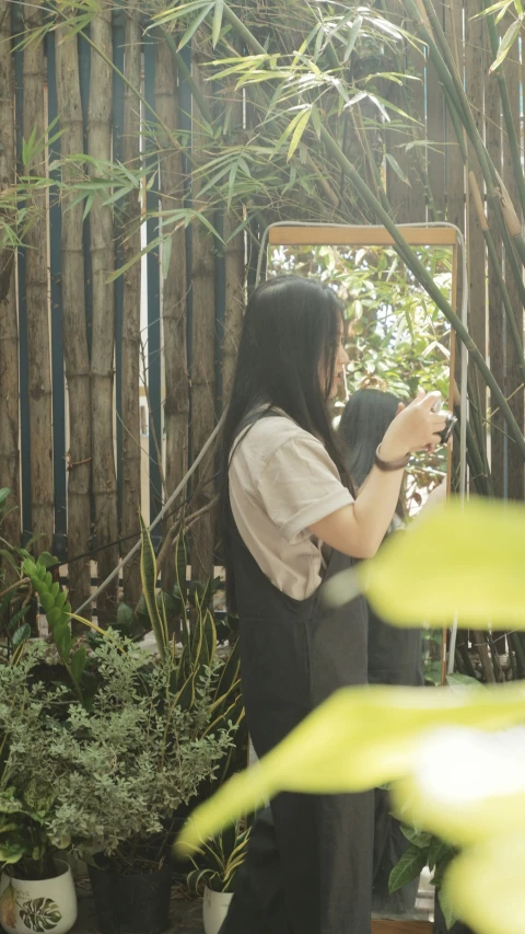 a person taking a picture of herself in front of a mirror