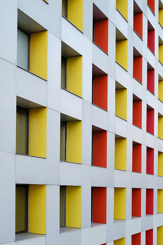 an abstract white building has bright yellow, red, and blue shades