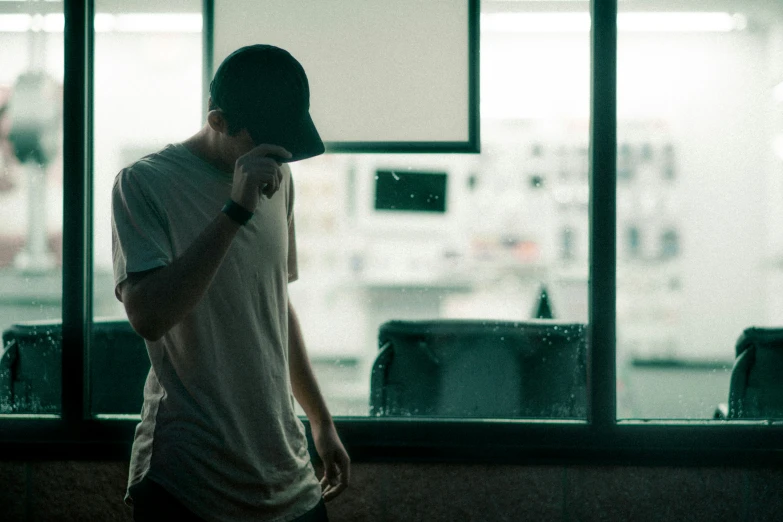 a person looking out the window while holding a phone to their ear