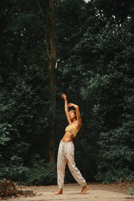 a girl with no top standing near a forest