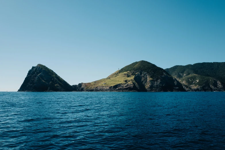 two different types of rock in the middle of a body of water