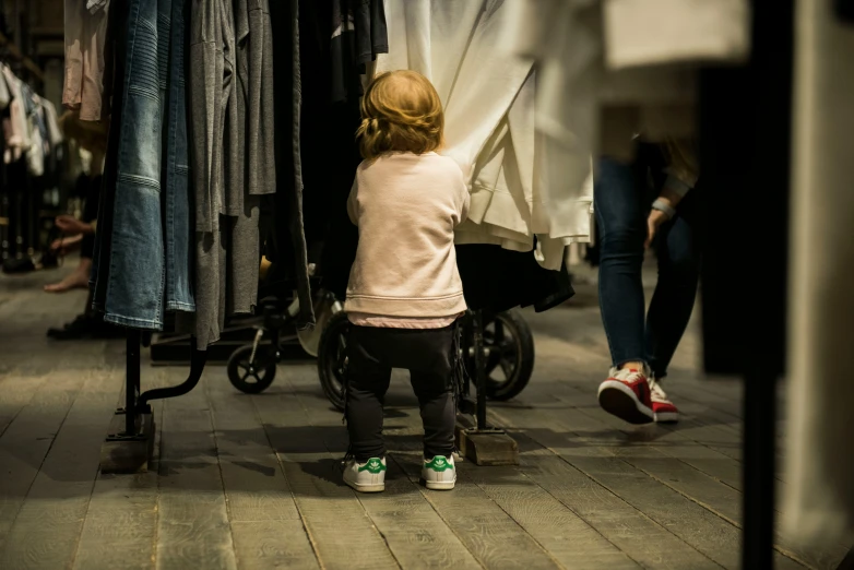 the small child is sitting near a rail