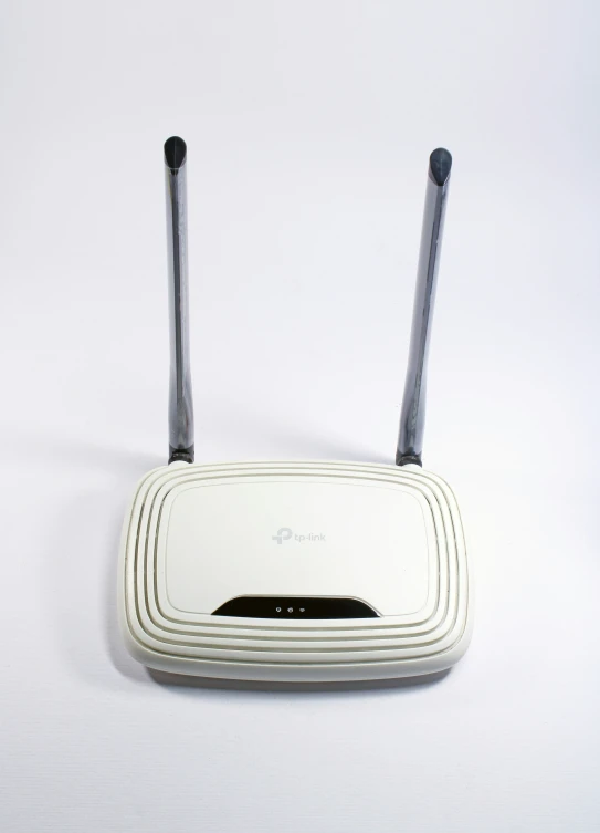 a white and grey wireless device with one antenna on top