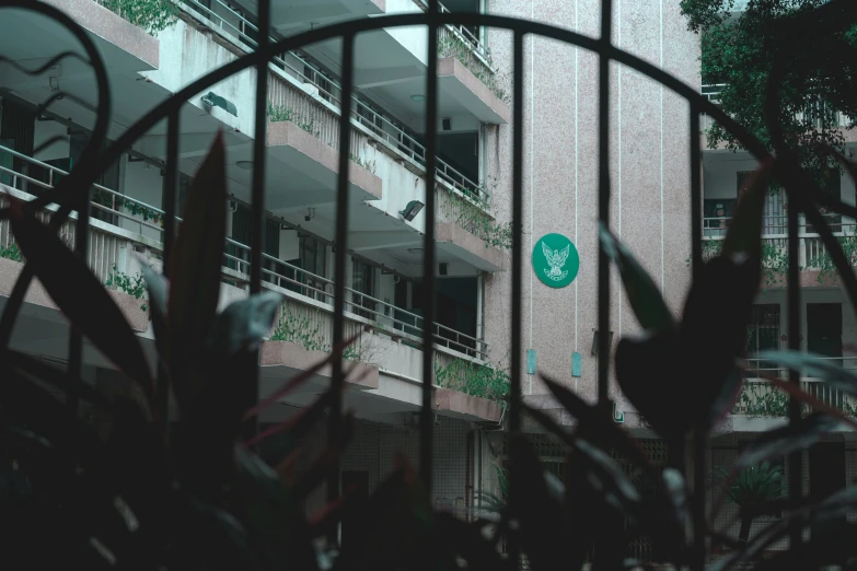 a green and white street sign in front of a building