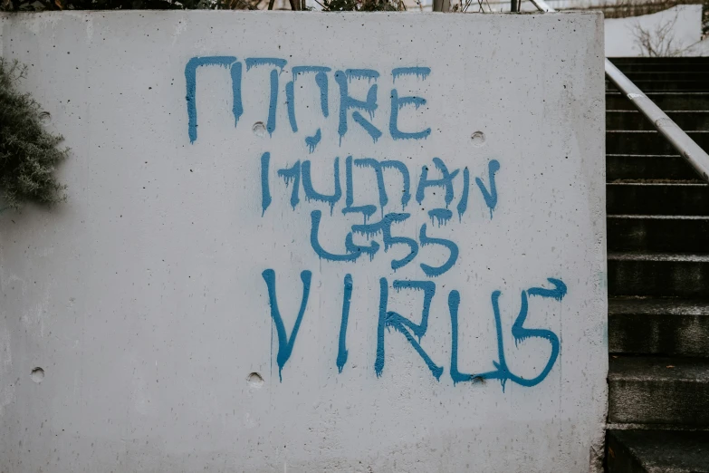 graffiti in blue on white wall that reads, future truman gets vinels