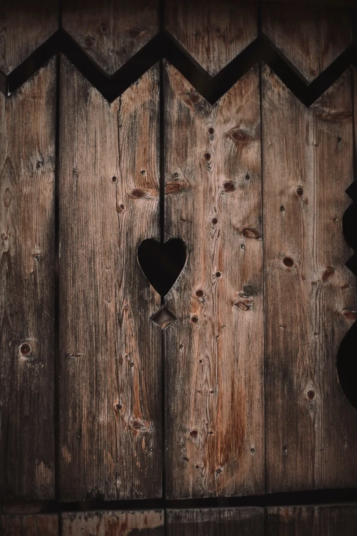 a wooden fence with a heart shaped hole