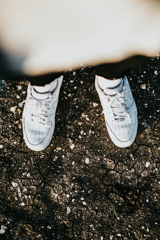 someone's feet with their white shoes on while they stand together