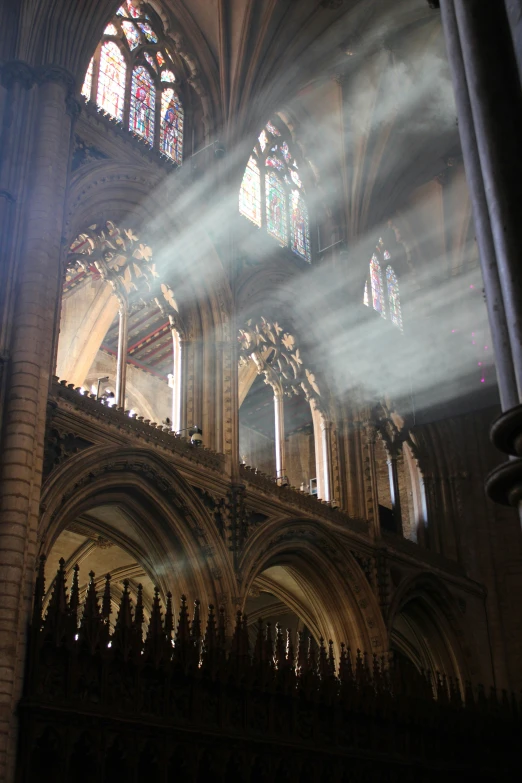 sunlight streaming through two large stained glass windows