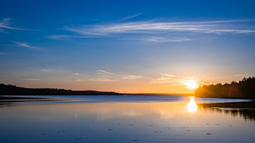 a large body of water sitting under a cloudy sky