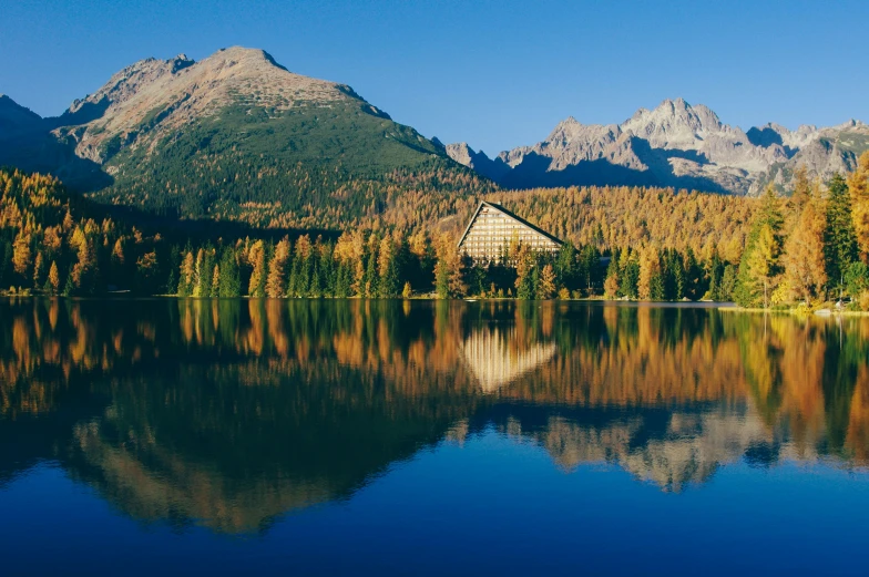 a house is in the background while mountains surround it