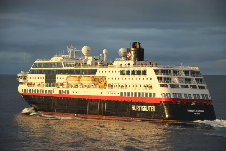 a large white and red ship in the ocean