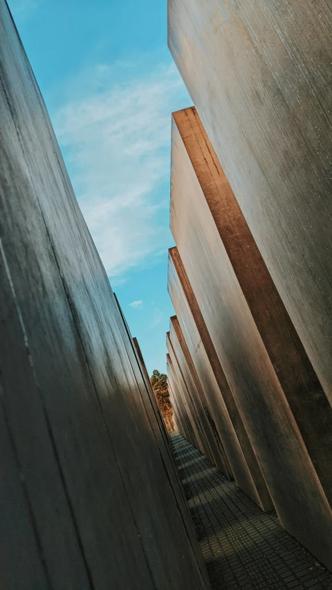 a row of large concrete buildings with a sky background