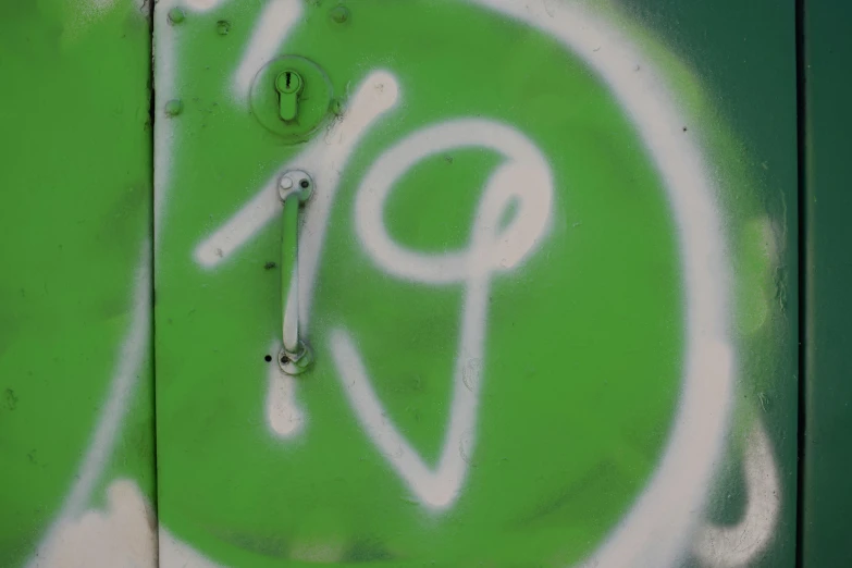 a green door with a white capital and numbers