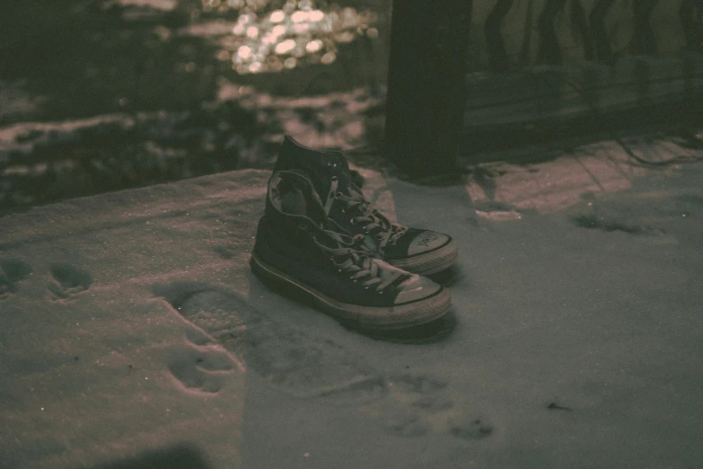 a person's sneakers on a cement sidewalk