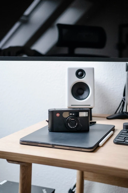 an old camera and computer on a desk