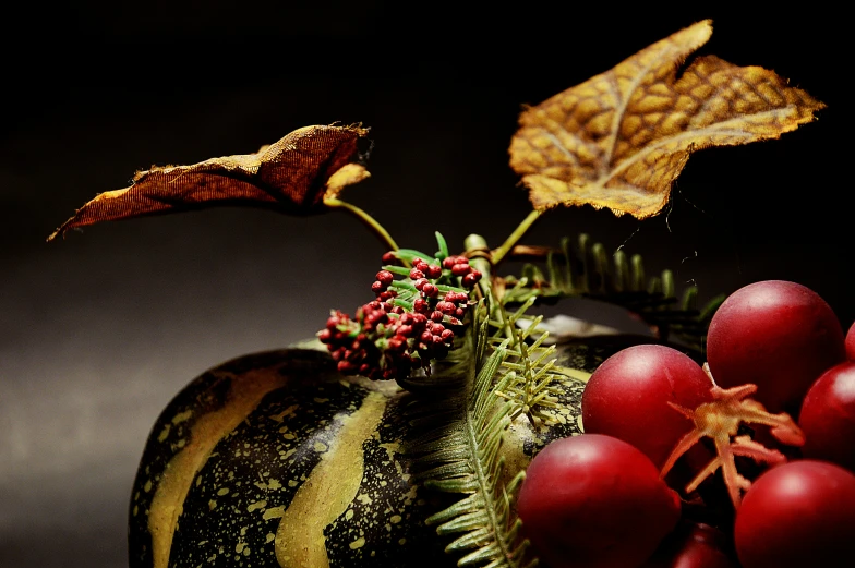 a group of apples are next to red berries