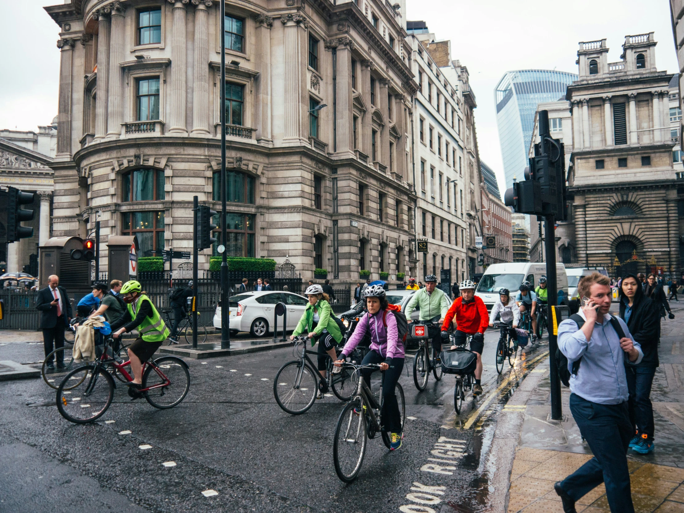 there are many people riding bicycles down the street