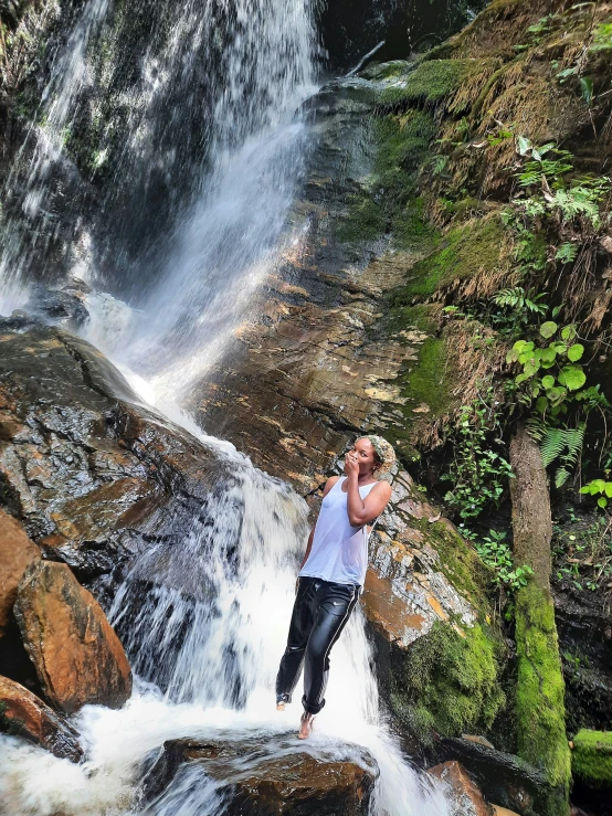 a man standing in the middle of a waterfall