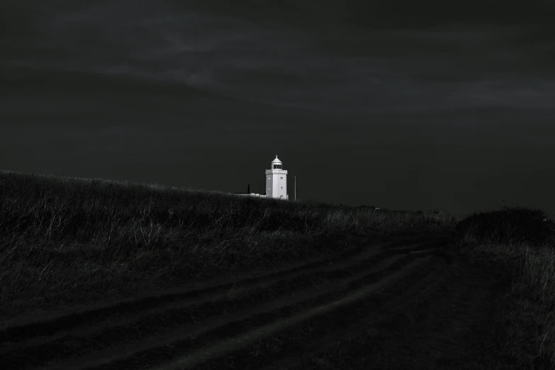 a road passes by a tower on a hill