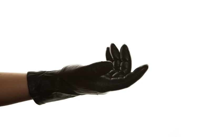 a black gloves that is being held in the air