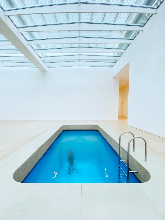 a pool inside of a building, next to a staircase