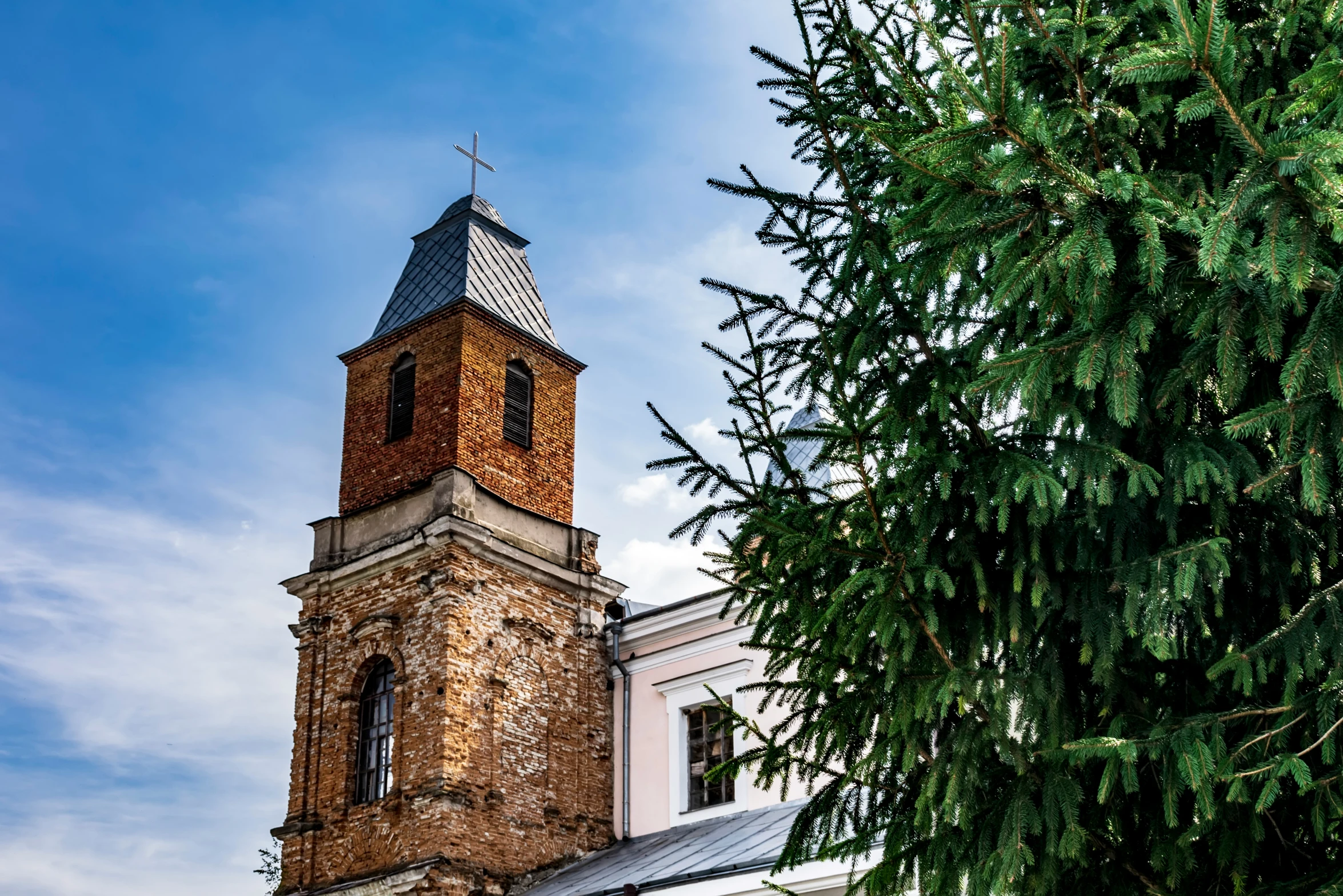 a church tower with a steeple and a clock